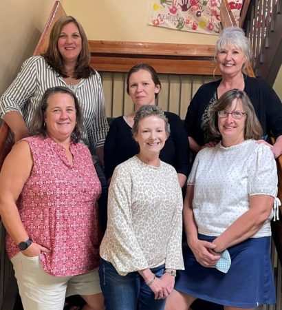 All of the DHH Outreach standing together on a staircase.